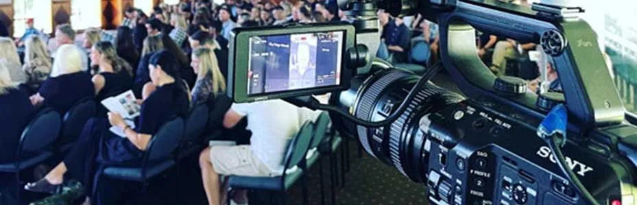 Professional camera filming a service from the back of the room for a private live stream